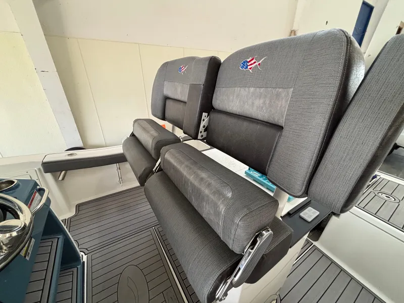 Slide: The Image of 2022 Crevalle 26 HCO boat dashboard with dual Simrad displays and chrome steering wheel. - 8