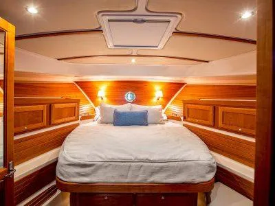 Slide: The Image of Luxurious cabin interior of 2026 Back Cove 372 yacht with wood paneling and cozy bedding. - 10
