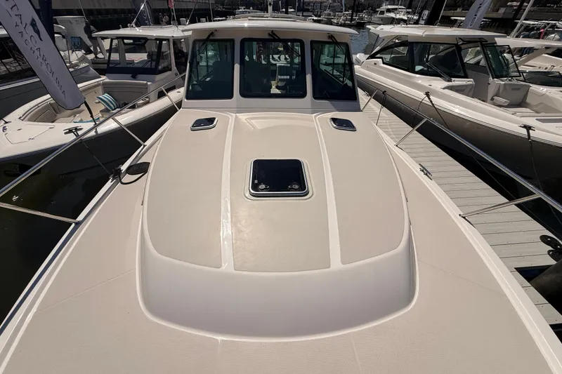 Slide: The Image of 2026 Back Cove 372 yacht deck view at marina, showcasing sleek design and modern features. - 17