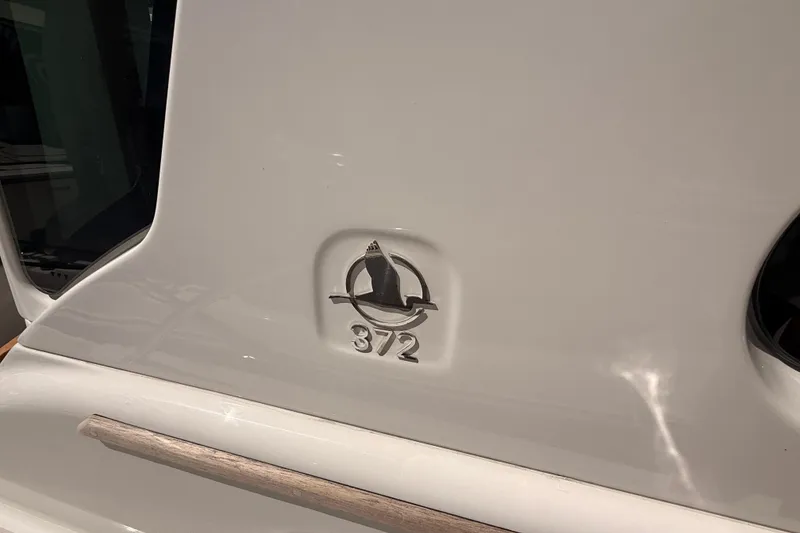 Slide: The Image of 2026 Back Cove 372 boat emblem on white surface. - 20