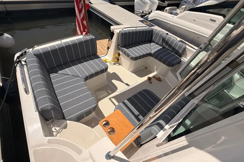 Slide: The Image of 2026 Back Cove 372 boat with striped seating and dock view. - 21