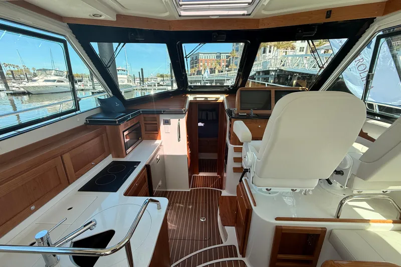 Slide: The Image of Interior of 2026 Back Cove 372 yacht with modern helm and galley area. - 24