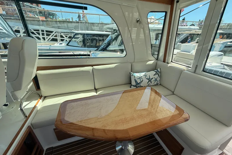 Slide: The Image of Interior of 2026 Back Cove 372 yacht with elegant seating and wooden table. - 31