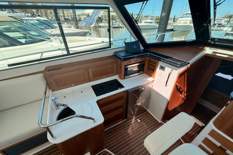Slide: The Image of Interior of 2026 Back Cove 372 yacht with modern kitchen and seating area. - 33