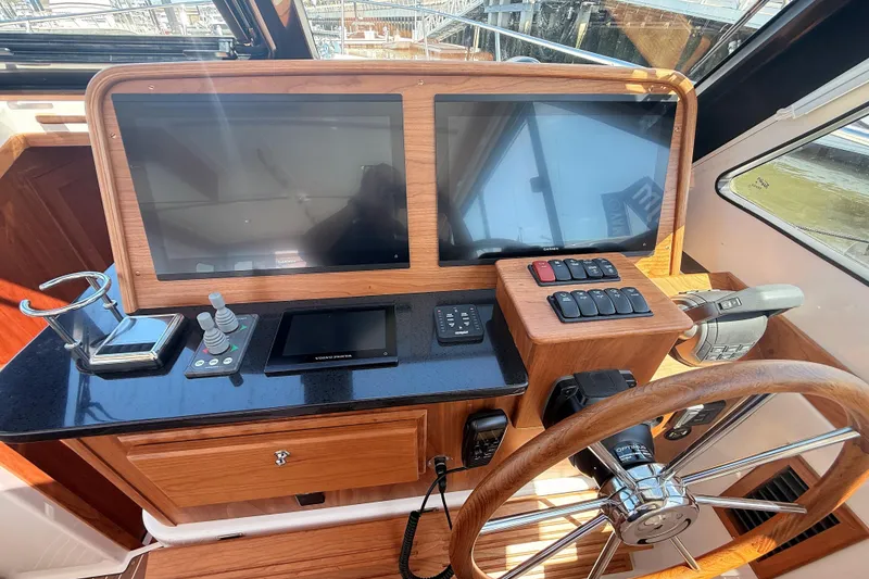 Slide: The Image of Helm station of 2026 Back Cove 372 yacht with dual screens and wooden steering wheel. - 35