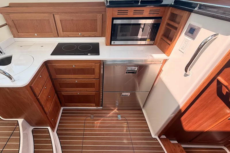 Slide: The Image of Modern galley kitchen in 2026 Back Cove 372 yacht with wood cabinetry and appliances. - 36