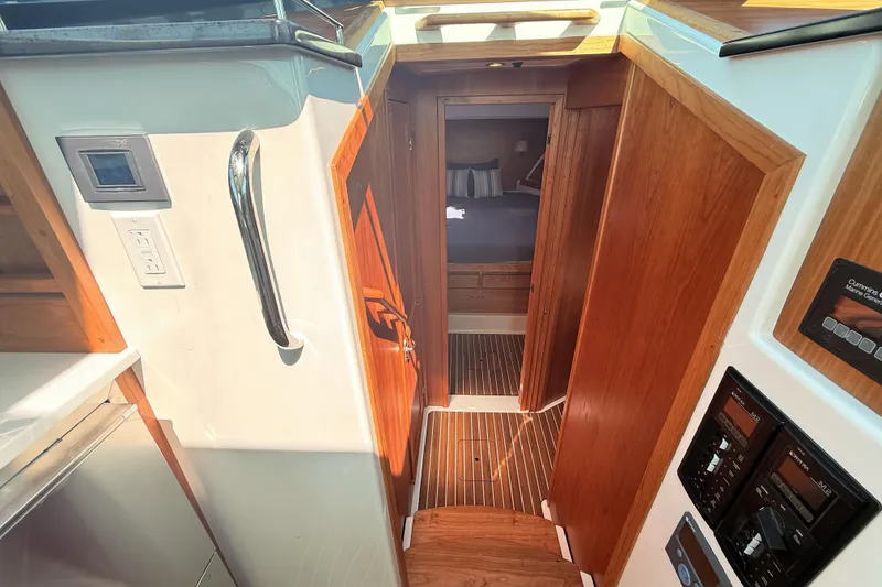 Slide: The Image of Interior view of 2026 Back Cove 372 yacht, featuring wooden finishes and modern controls. - 38