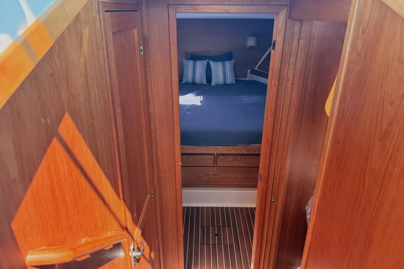 Slide: The Image of 2026 Back Cove 372 yacht interior with wooden cabin and cozy bed. - 39