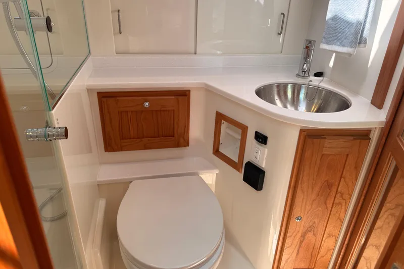 Slide: The Image of Modern bathroom in 2026 Back Cove 372 yacht with sink, toilet, and wooden cabinetry. - 40