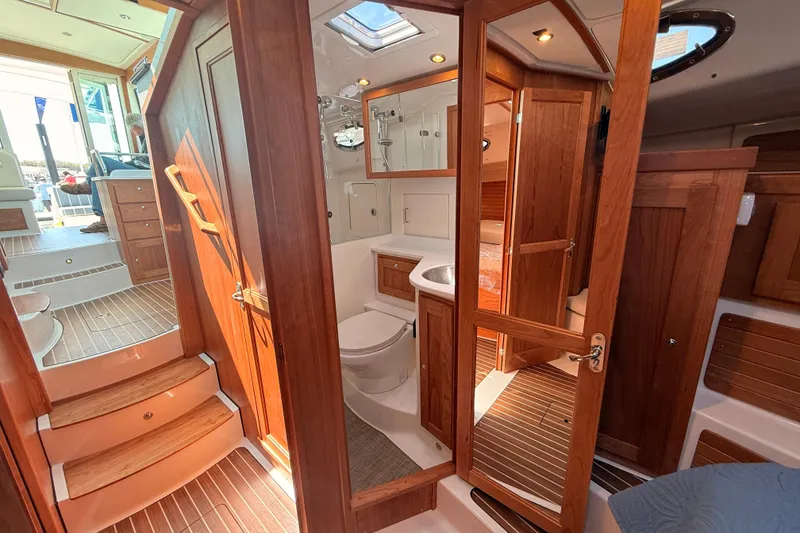 Slide: The Image of Interior of 2026 Back Cove 372 yacht featuring wooden cabinetry and modern amenities. - 44