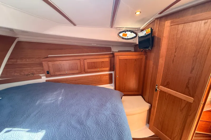 Slide: The Image of Cozy cabin interior of 2026 Back Cove 372 yacht with wood paneling and bed. - 46