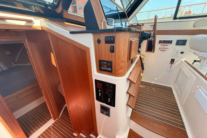 Slide: The Image of Interior view of 2026 Back Cove 372 boat, showcasing helm and cabin entrance. - 48