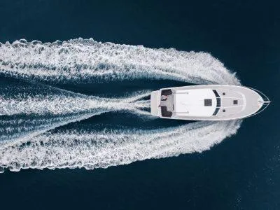 Slide: The Image of Aerial view of 2026 Back Cove 372 yacht cruising on open water. - 49