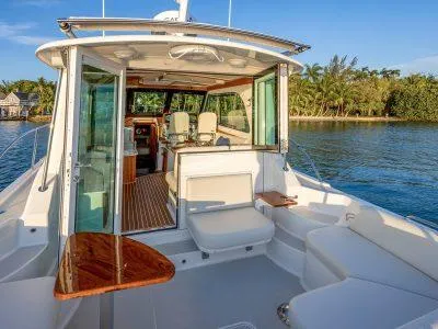 Slide: The Image of 2026 Back Cove 372 yacht with open deck, luxurious seating, and scenic water view. - 5