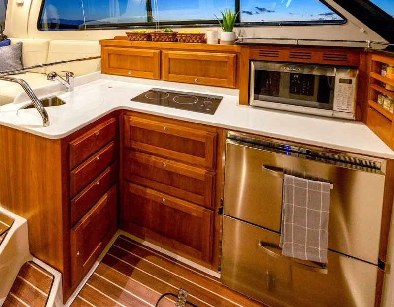 Slide: The Image of Luxurious 2026 Back Cove 372 yacht kitchen with modern appliances and elegant wood cabinetry. - 9