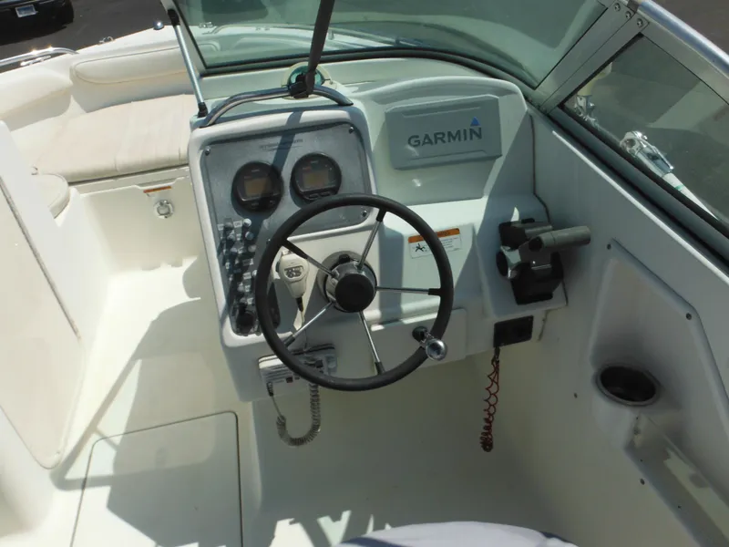 Slide: The Image of 2004 Hydra-Sports Lightning 202 DC boat cockpit with Garmin navigation system and steering wheel. - 12