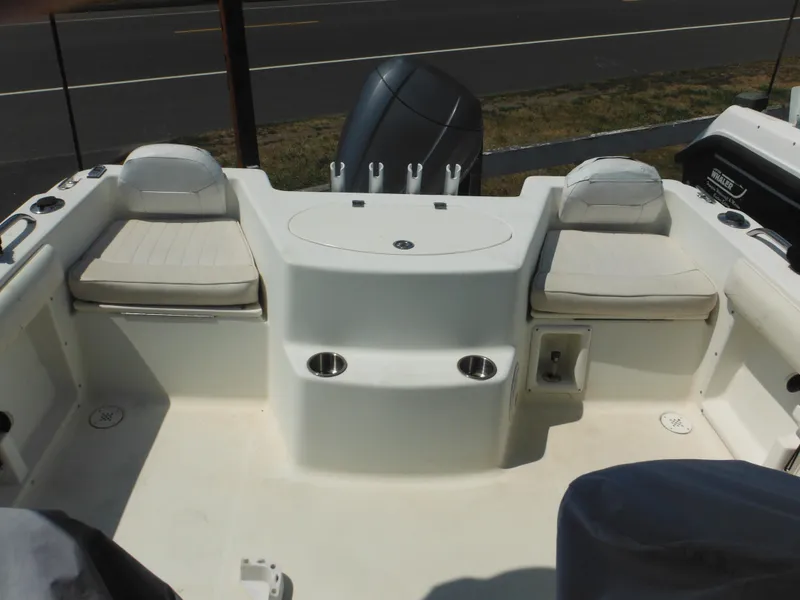 Slide: The Image of 2004 Hydra-Sports Lightning 202 DC boat interior with cushioned seating and storage compartments. - 14