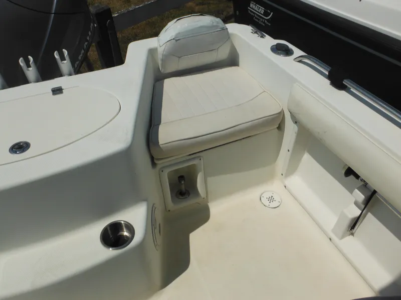 Slide: The Image of 2004 Hydra-Sports Lightning 202 DC boat interior with cushioned seating and cup holder. - 15