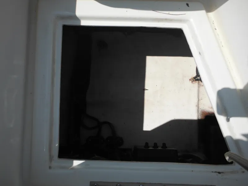 Slide: The Image of 2004 Hydra-Sports Lightning 202 DC storage compartment, partially shadowed, with visible wiring. - 20