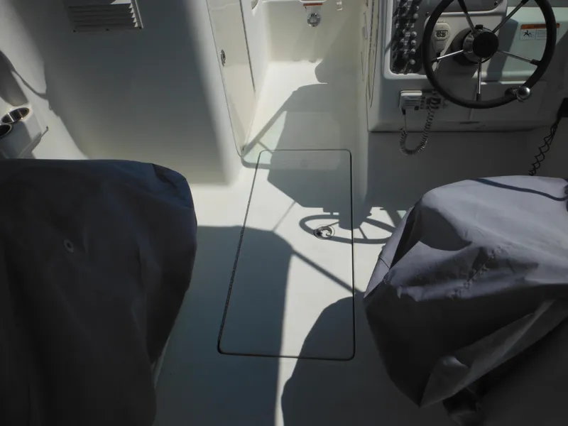 Slide: The Image of 2004 Hydra-Sports Lightning 202 DC boat interior with steering wheel and covered seats. - 21