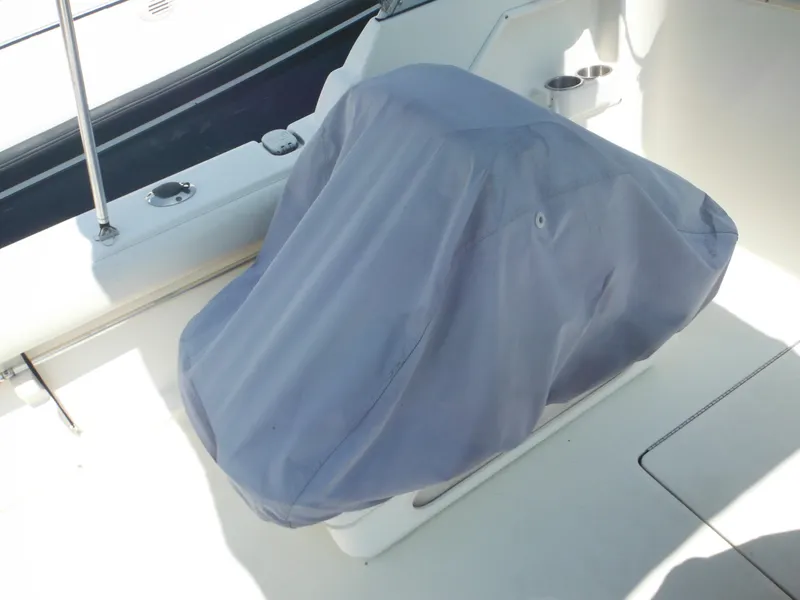 Slide: The Image of 2004 Hydra-Sports Lightning 202 DC boat seat covered with a protective gray cover. - 23