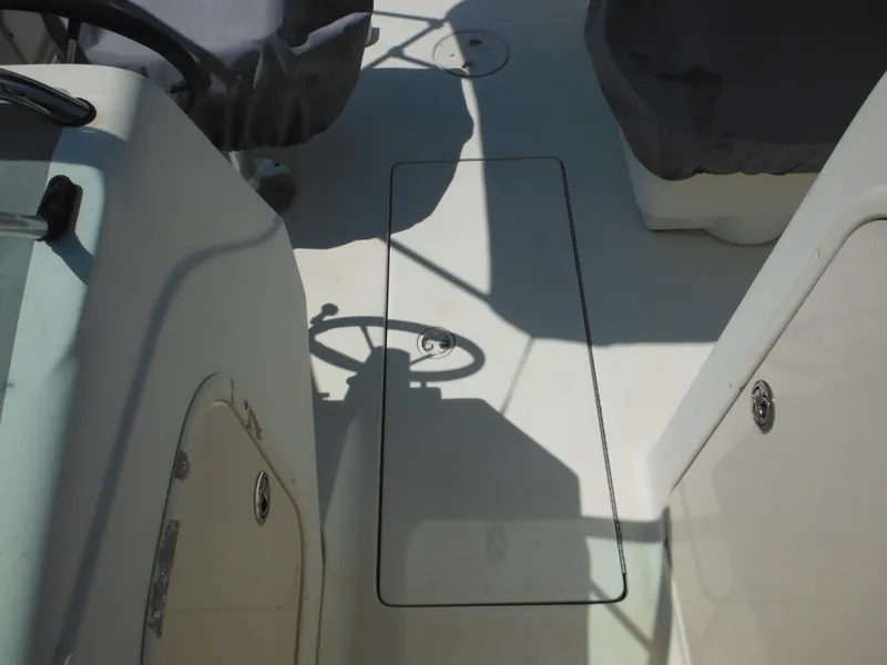 Slide: The Image of 2004 Hydra-Sports Lightning 202 DC boat interior with covered seats and steering wheel. - 24