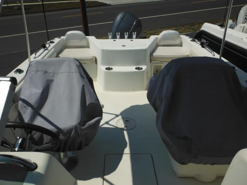 Slide: The Image of 2004 Hydra-Sports Lightning 202 DC boat interior with covered seats and steering wheel. - 25
