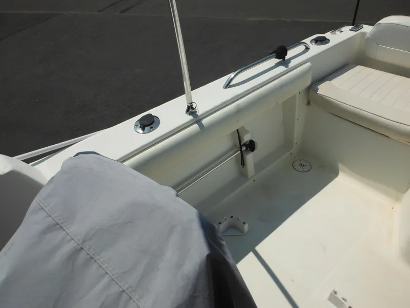 Slide: The Image of 2004 Hydra-Sports Lightning 202 DC boat interior with seating and covered equipment. - 28