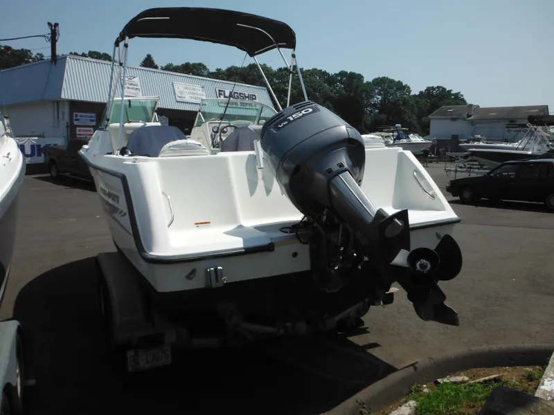 Slide: The Image of 2004 Hydra-Sports Lightning 202 DC boat with outboard motor in a marina setting. - 9