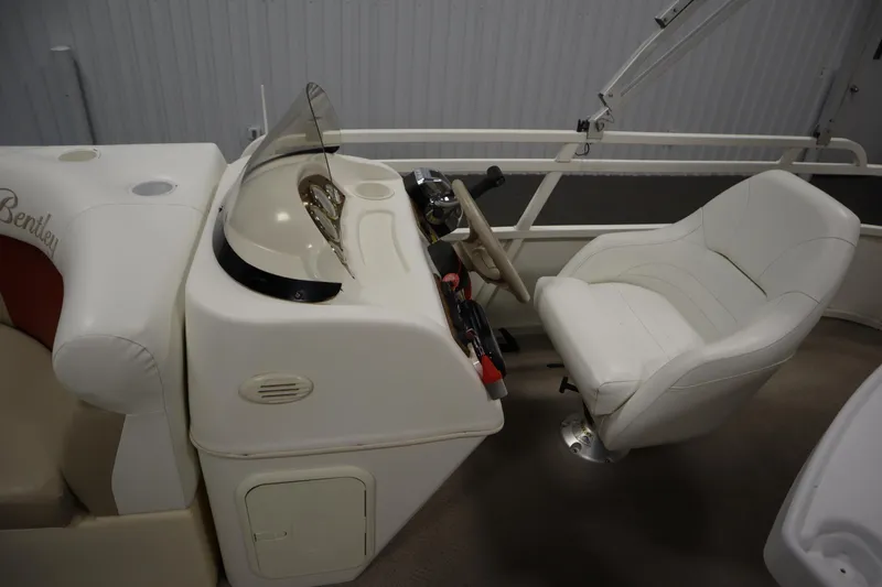 Slide: The Image of 2008 Bentley Pontoons 240 CRUISE interior with steering console and white captain's chair. - 17