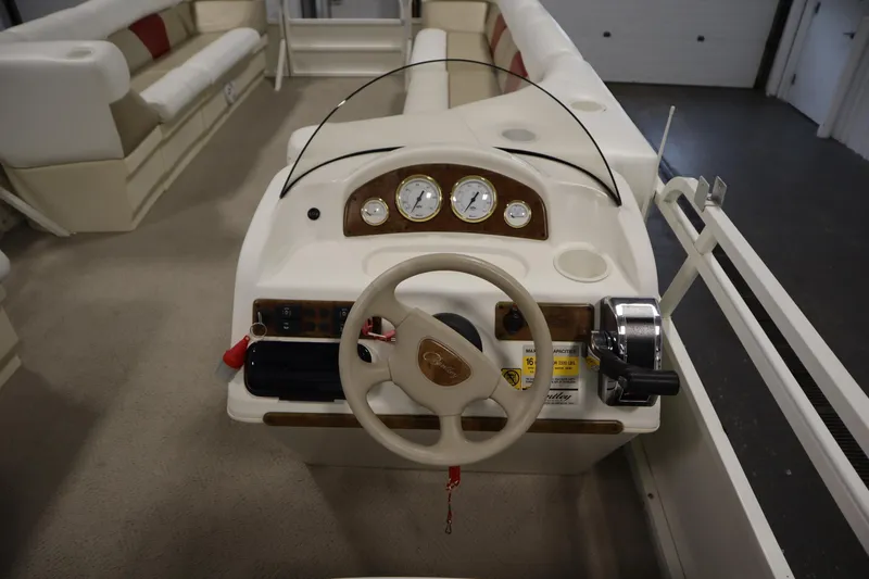 Slide: The Image of 2008 Bentley Pontoons 240 CRUISE dashboard with steering wheel and gauges. - 19