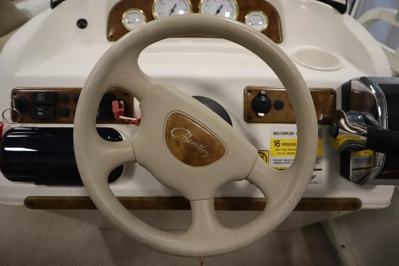 Slide: The Image of Steering wheel of 2008 Bentley Pontoons 240 CRUISE with dashboard controls. - 20