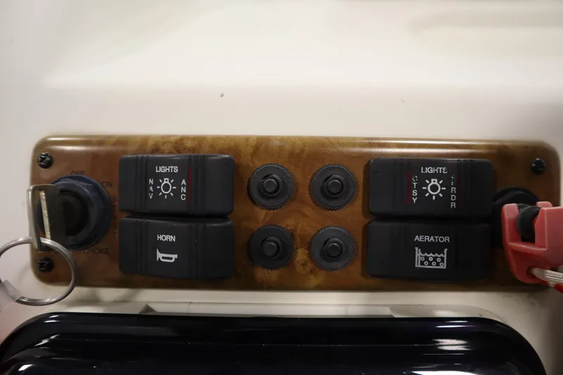 Slide: The Image of Control panel of a 2008 Bentley Pontoons 240 CRUISE with switches for lights, horn, and aerator. - 23