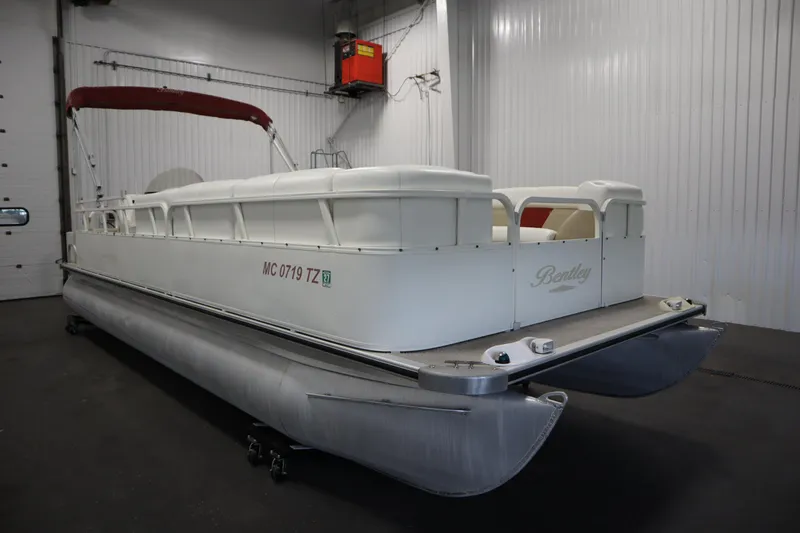 Slide: The Image of 2008 Bentley Pontoons 240 CRUISE in a garage, featuring a white and red design. - 3