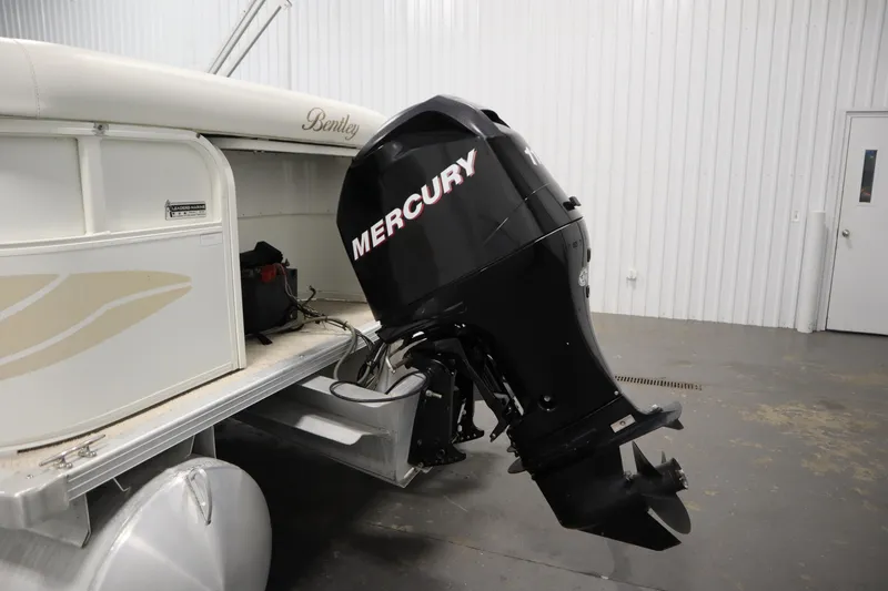 Slide: The Image of 2008 Bentley Pontoons 240 CRUISE with Mercury outboard motor in a garage setting. - 40