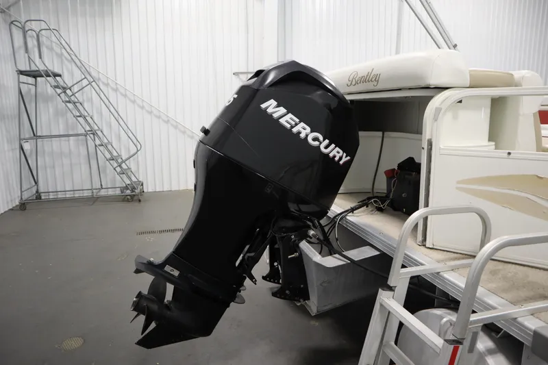 Slide: The Image of 2008 Bentley Pontoons 240 CRUISE with Mercury outboard motor in a storage facility. - 41