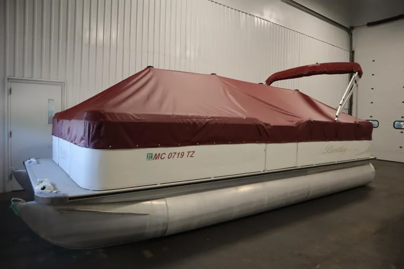 Slide: The Image of 2008 Bentley Pontoons 240 CRUISE with maroon cover in indoor storage. - 48