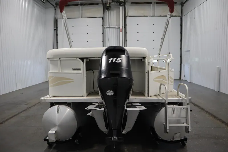 Slide: The Image of 2008 Bentley Pontoons 240 CRUISE in a garage, rear view with motor and ladder. - 6