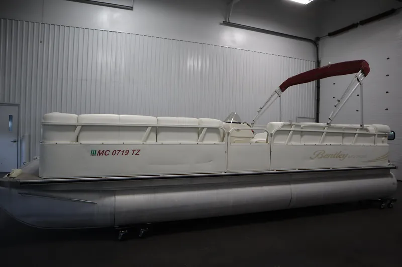 Slide: The Image of 2008 Bentley Pontoons 240 CRUISE pontoon boat with red canopy in indoor storage. - 8