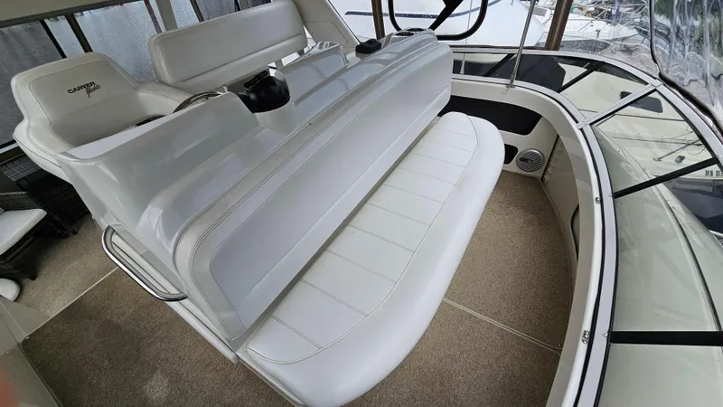 Slide: The Image of 1997 Carver 355 Motor Yacht interior with white seating and helm station. - 10