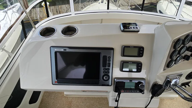 Slide: The Image of 1997 Carver 355 Motor Yacht helm with navigation equipment and control panel. - 13
