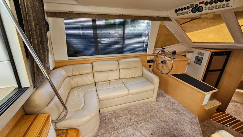 Slide: The Image of Interior of 1997 Carver 355 Motor Yacht with beige leather seating and helm station. - 17
