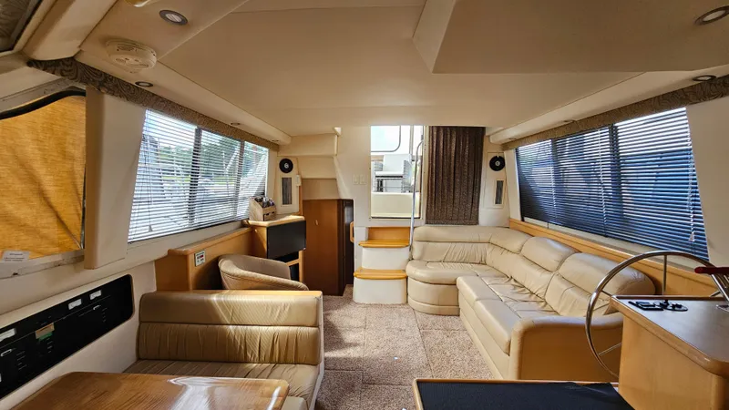 Slide: The Image of Luxurious interior of 1997 Carver 355 Motor Yacht with beige leather seating. - 20
