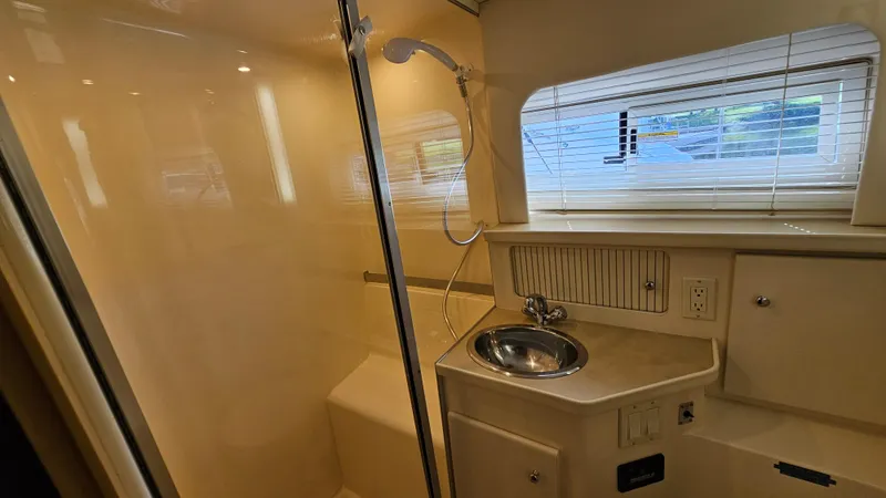 Slide: The Image of 1997 Carver 355 Motor Yacht bathroom with shower, sink, and window blinds. - 30
