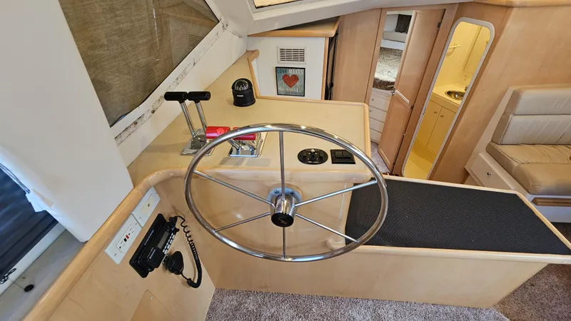 Slide: The Image of Interior helm of 1997 Carver 355 Motor Yacht with steering wheel and controls. - 31