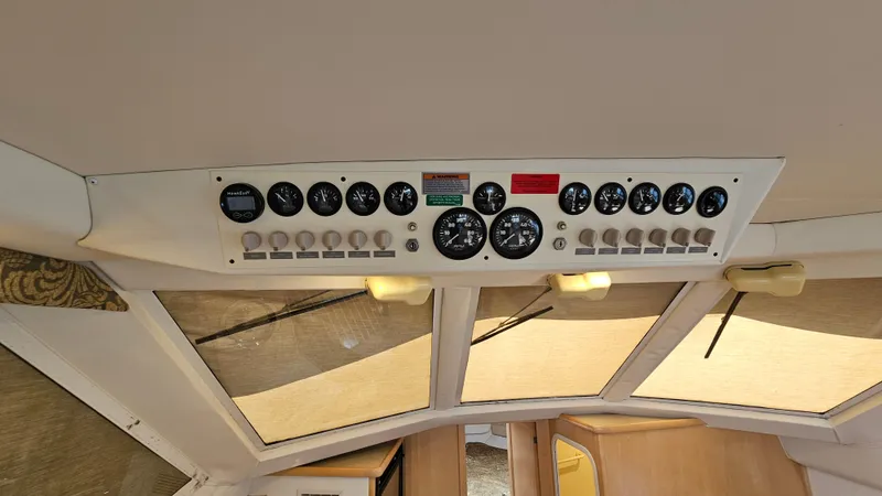 Slide: The Image of Control panel of a 1997 Carver 355 Motor Yacht with gauges and switches. - 32