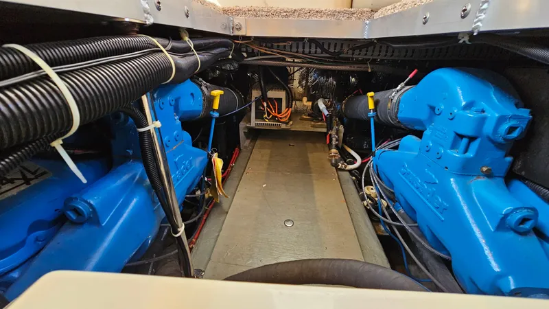 Slide: The Image of Engine room of a 1997 Carver 355 Motor Yacht with blue machinery components. - 34