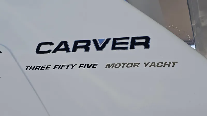 Slide: The Image of 1997 Carver 355 Motor Yacht logo on white surface. - 35
