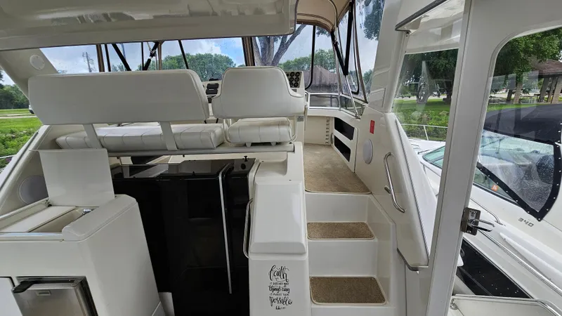 Slide: The Image of 1997 Carver 355 Motor Yacht interior with white seating and steps, showcasing luxury design. - 7