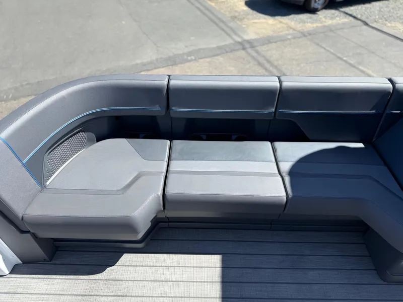 Slide: The Image of Luxurious seating on 2025 Manitou Explore Dual Engine boat, featuring sleek gray upholstery. - 11